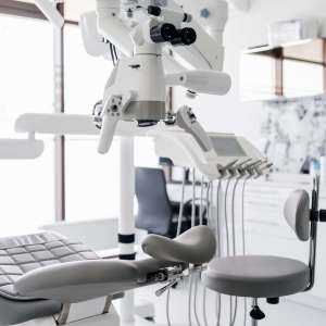 Interior of dental practice room with chair, lamp, display and stomatological tools